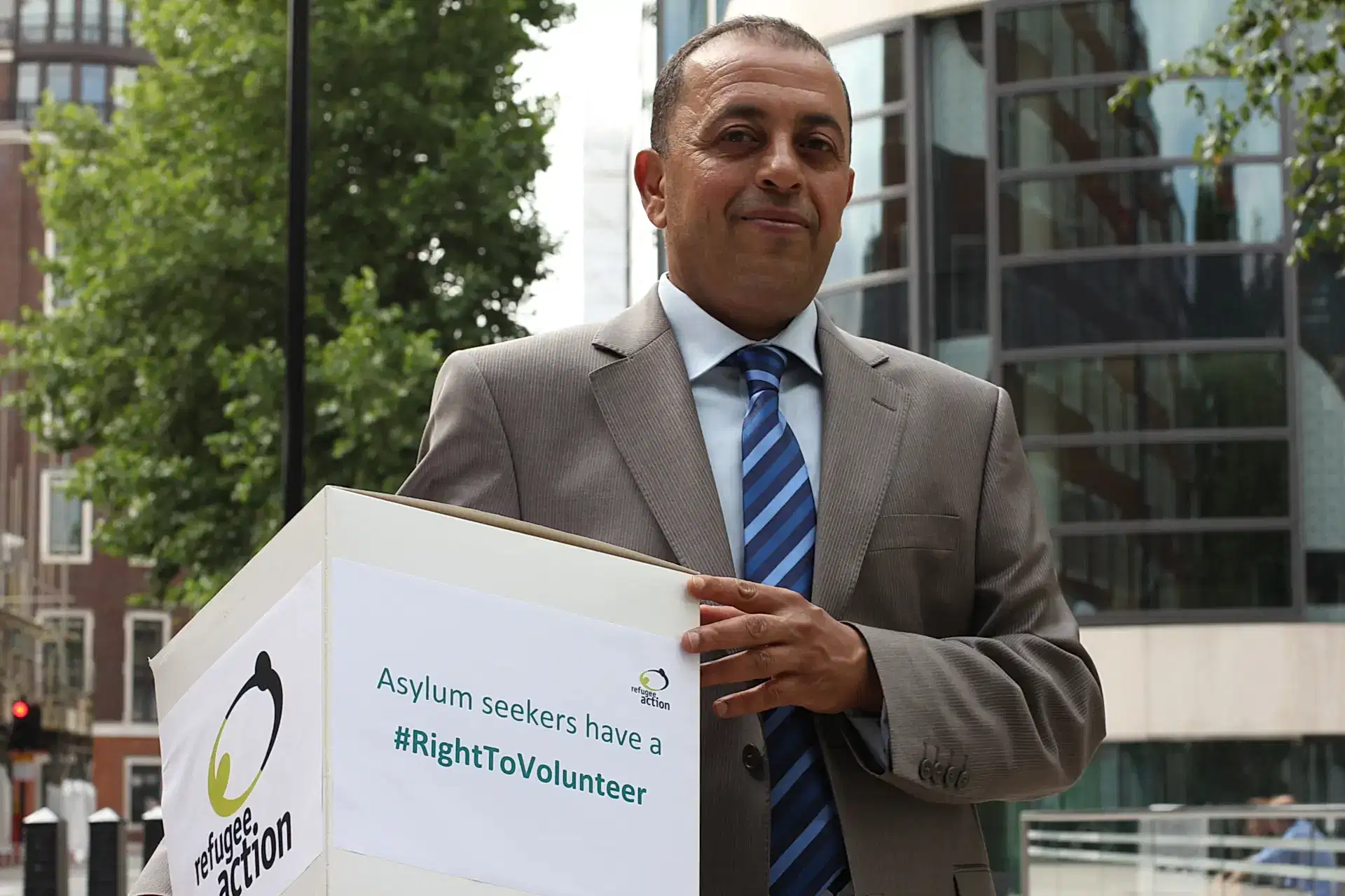 Refugee Action volunteer Nabil hands in the right to volunteer petition to the Home Secretary Photo Refugee Action
